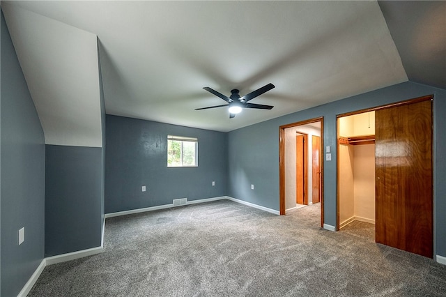 unfurnished bedroom featuring carpet floors, lofted ceiling, and ceiling fan