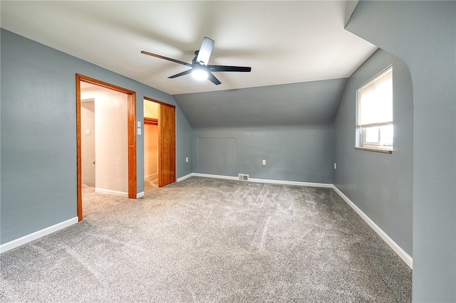 additional living space featuring ceiling fan, lofted ceiling, and carpet flooring