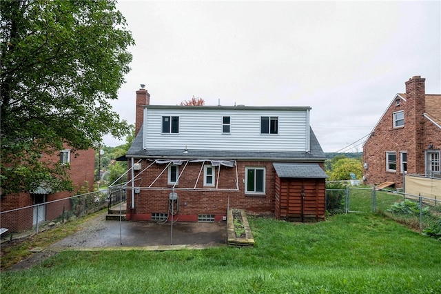 back of property with a lawn and a patio