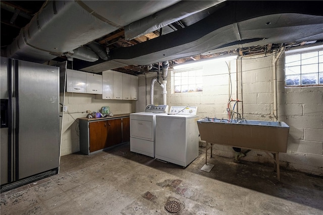 laundry room with washer and clothes dryer, cabinets, plenty of natural light, and sink