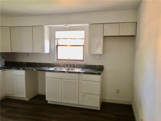 kitchen with white cabinets, dark hardwood / wood-style floors, and sink