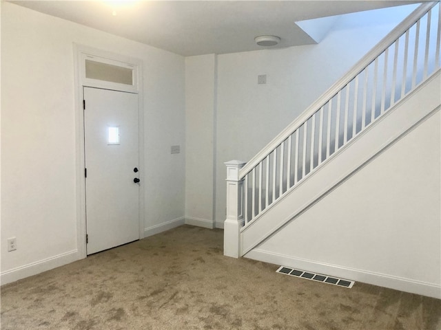 entrance foyer with light colored carpet