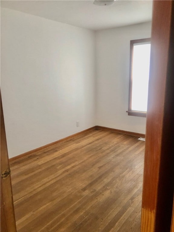 spare room featuring hardwood / wood-style flooring