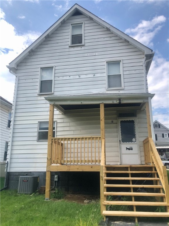 rear view of house featuring cooling unit and a deck