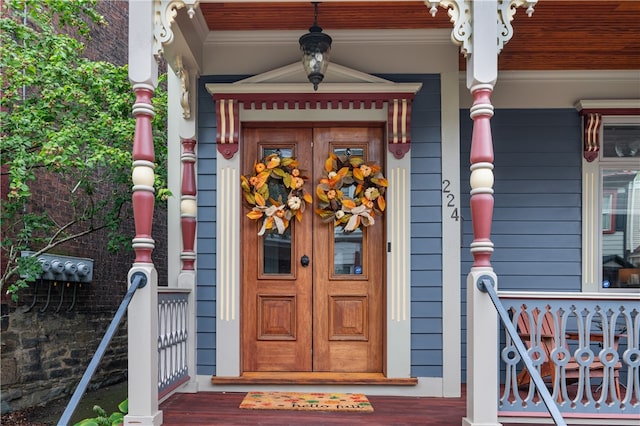 view of exterior entry with covered porch