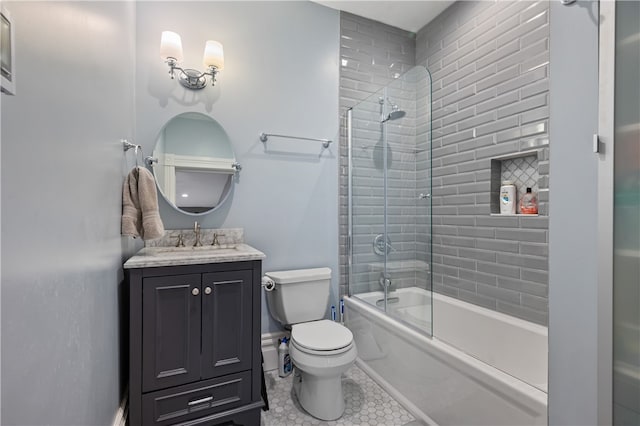 full bathroom featuring vanity, combined bath / shower with glass door, and toilet