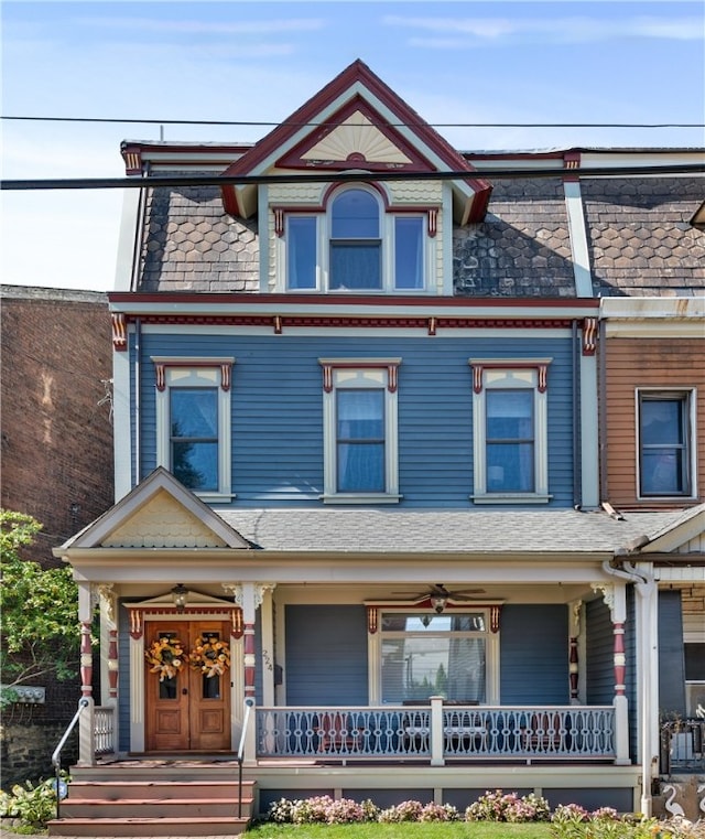 victorian-style house featuring a porch and ceiling fan