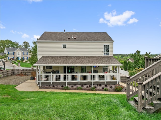 rear view of property with a yard