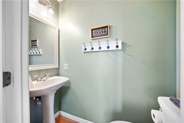 bathroom featuring toilet and hardwood / wood-style flooring