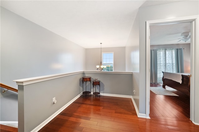 hallway featuring a chandelier and hardwood / wood-style floors