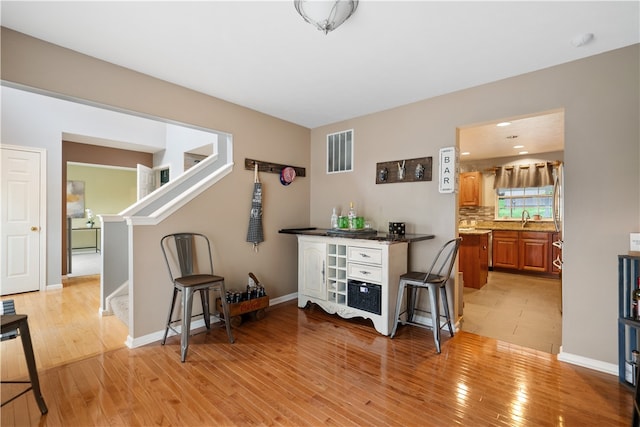 misc room featuring light hardwood / wood-style floors and sink