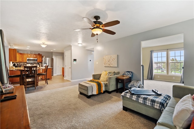 carpeted living room with ceiling fan