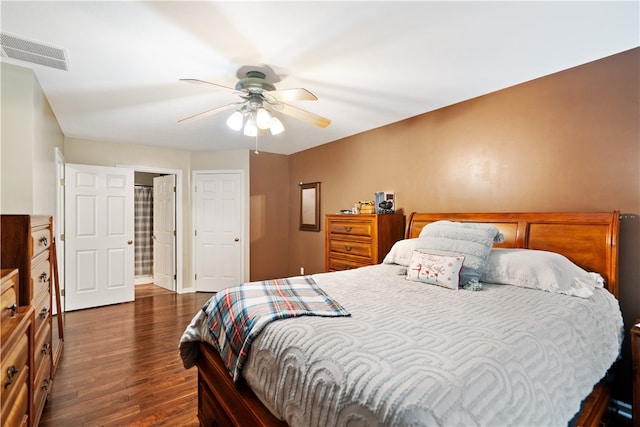 bedroom with dark hardwood / wood-style floors and ceiling fan