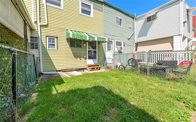 rear view of property with a lawn