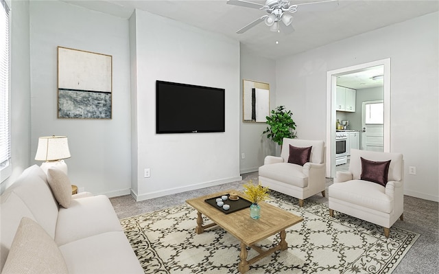 living room featuring ceiling fan and light colored carpet