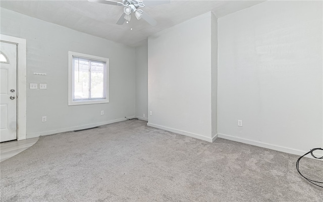 carpeted empty room featuring ceiling fan