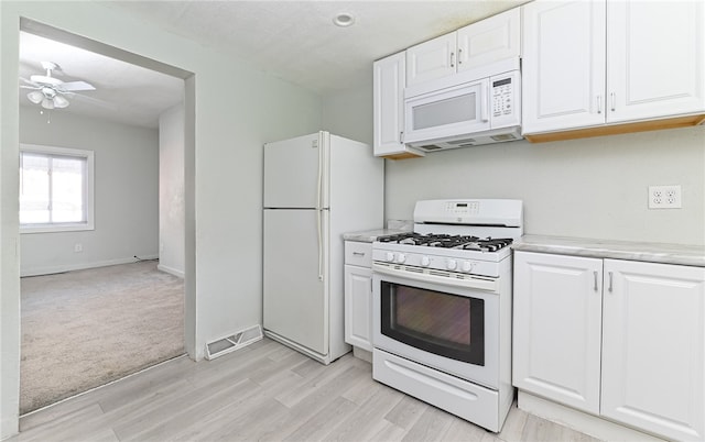 kitchen featuring light hardwood / wood-style floors, ceiling fan, white cabinetry, and white appliances