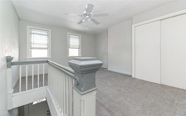 interior space featuring carpet floors and ceiling fan