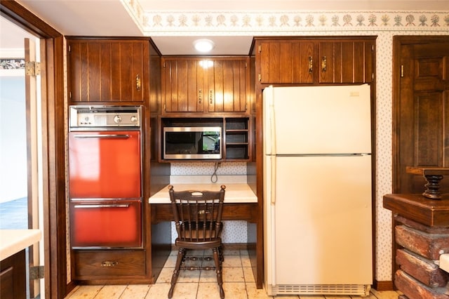 kitchen with white fridge and multiple ovens