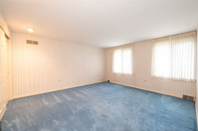 empty room with dark colored carpet