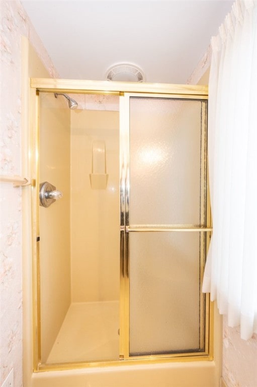 bathroom with a shower with shower door