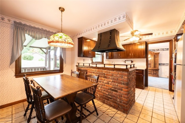 dining space featuring ceiling fan and light tile patterned flooring