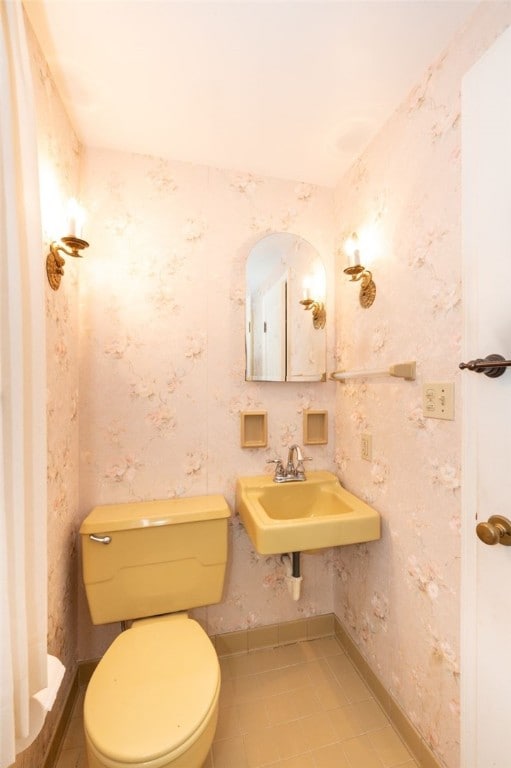 bathroom with sink, tile patterned floors, and toilet