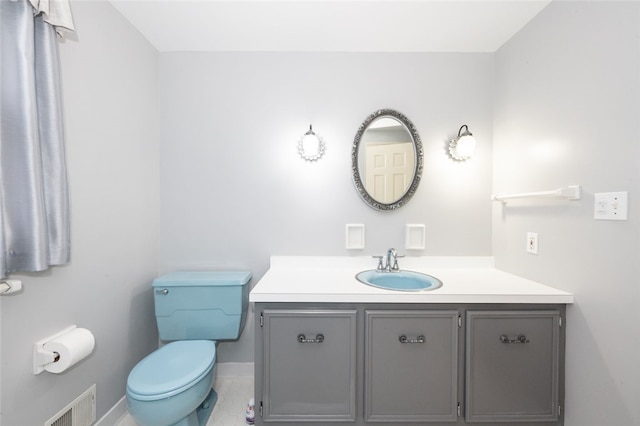 bathroom with tile patterned flooring, vanity, and toilet