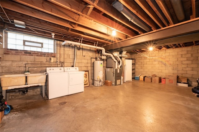 basement featuring gas water heater, sink, heating unit, and washing machine and clothes dryer