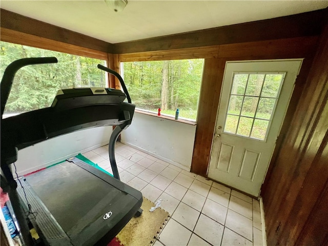 exercise room with light tile patterned floors