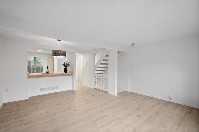 unfurnished living room featuring light hardwood / wood-style flooring