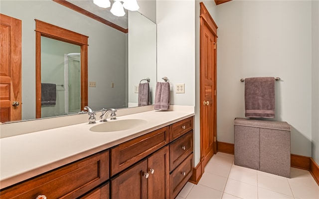 bathroom with vanity, crown molding, and tile patterned flooring