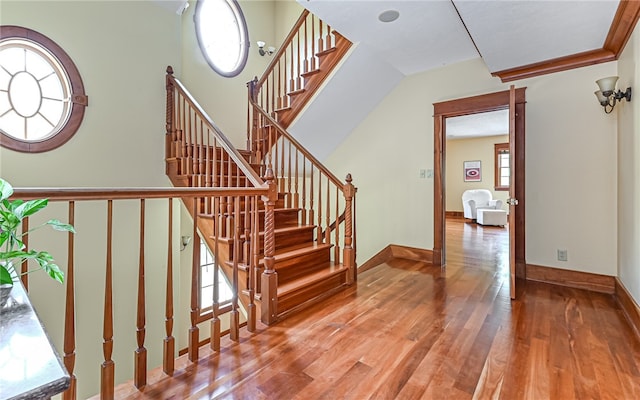 stairs featuring a healthy amount of sunlight and wood-type flooring