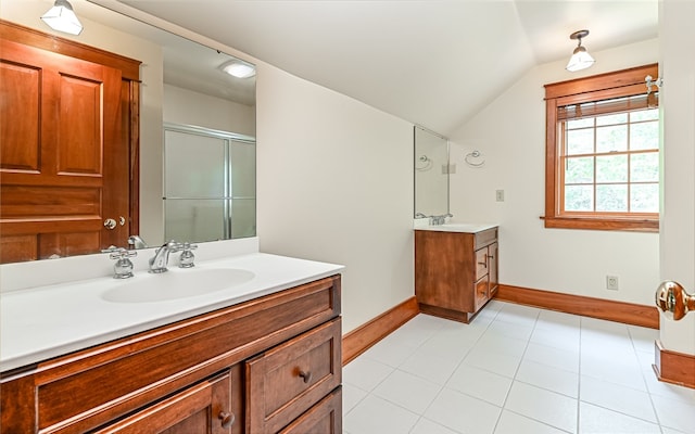 bathroom with tile patterned flooring, lofted ceiling, walk in shower, and vanity