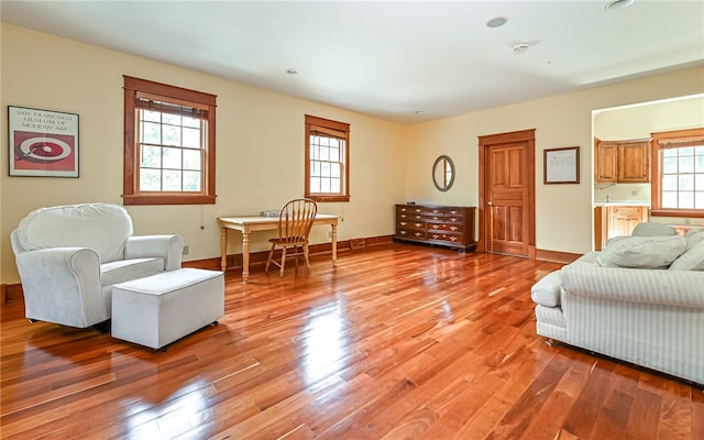 sitting room with a wealth of natural light and light hardwood / wood-style floors