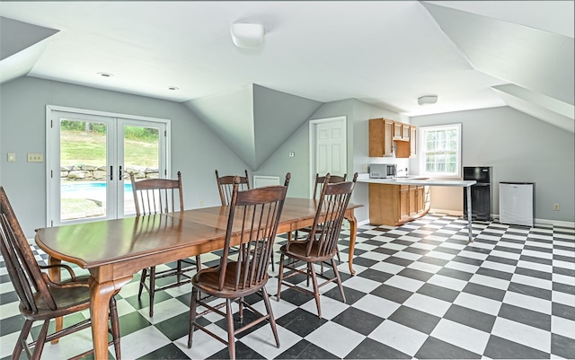 dining area featuring french doors, vaulted ceiling, and a healthy amount of sunlight