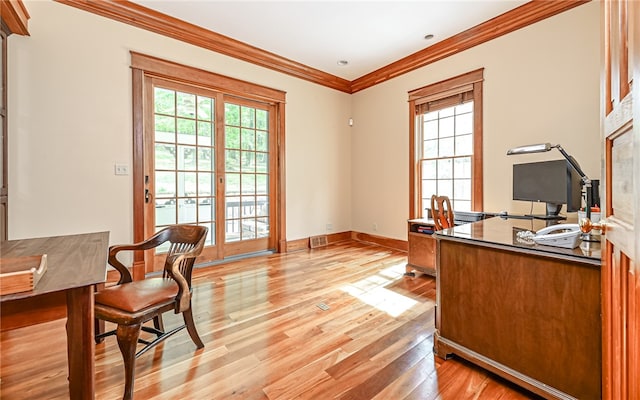 office space with light hardwood / wood-style floors and crown molding