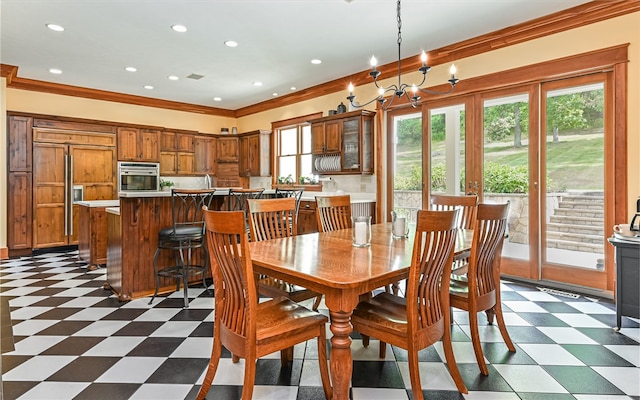 dining area with a notable chandelier and crown molding