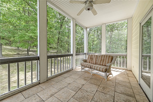 unfurnished sunroom with ceiling fan