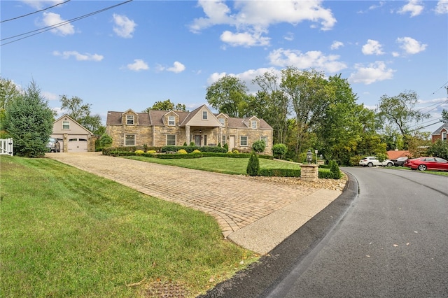 english style home featuring a front yard