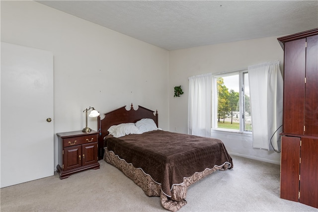 carpeted bedroom featuring a textured ceiling and lofted ceiling