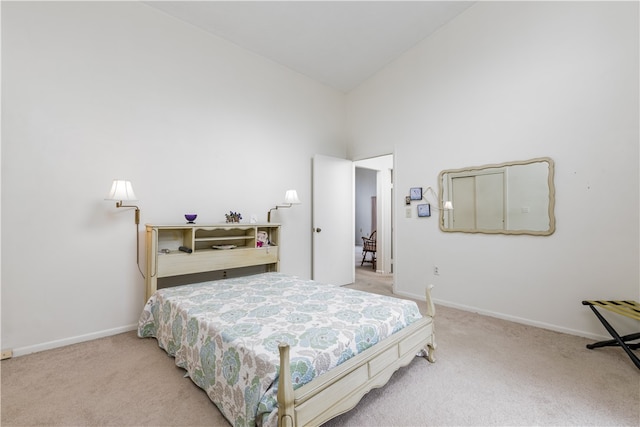 bedroom with light carpet and high vaulted ceiling