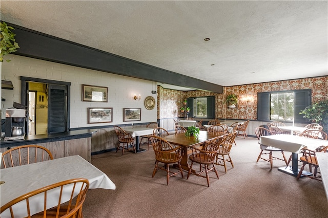 dining space featuring beam ceiling, a textured ceiling, and carpet floors