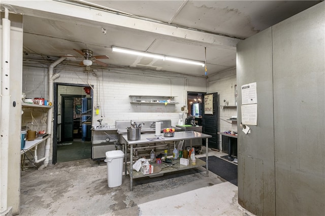 interior space featuring ceiling fan and a workshop area