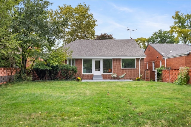 back of property featuring a lawn and a patio