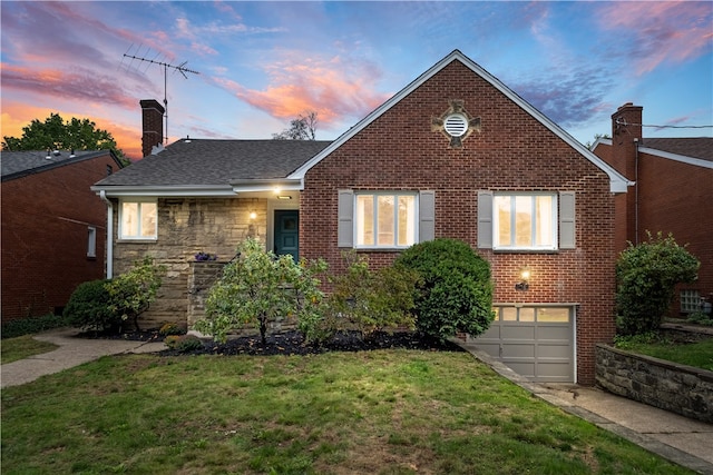 view of front of property featuring a lawn and a garage