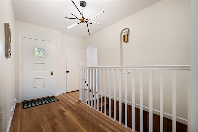 entryway featuring an inviting chandelier and hardwood / wood-style flooring