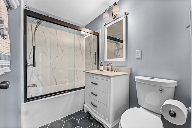 full bathroom with vanity, enclosed tub / shower combo, toilet, and tile patterned flooring