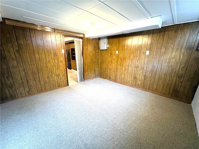 basement featuring wooden walls and carpet