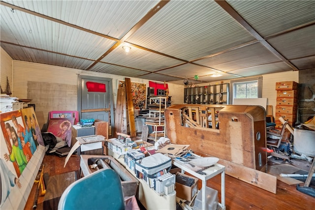 interior space with wood walls and hardwood / wood-style flooring